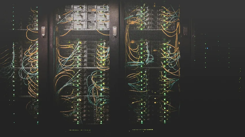 Computer servers in a rack connected by cables.
